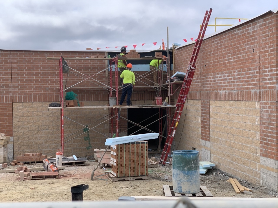 construction workers building a wall